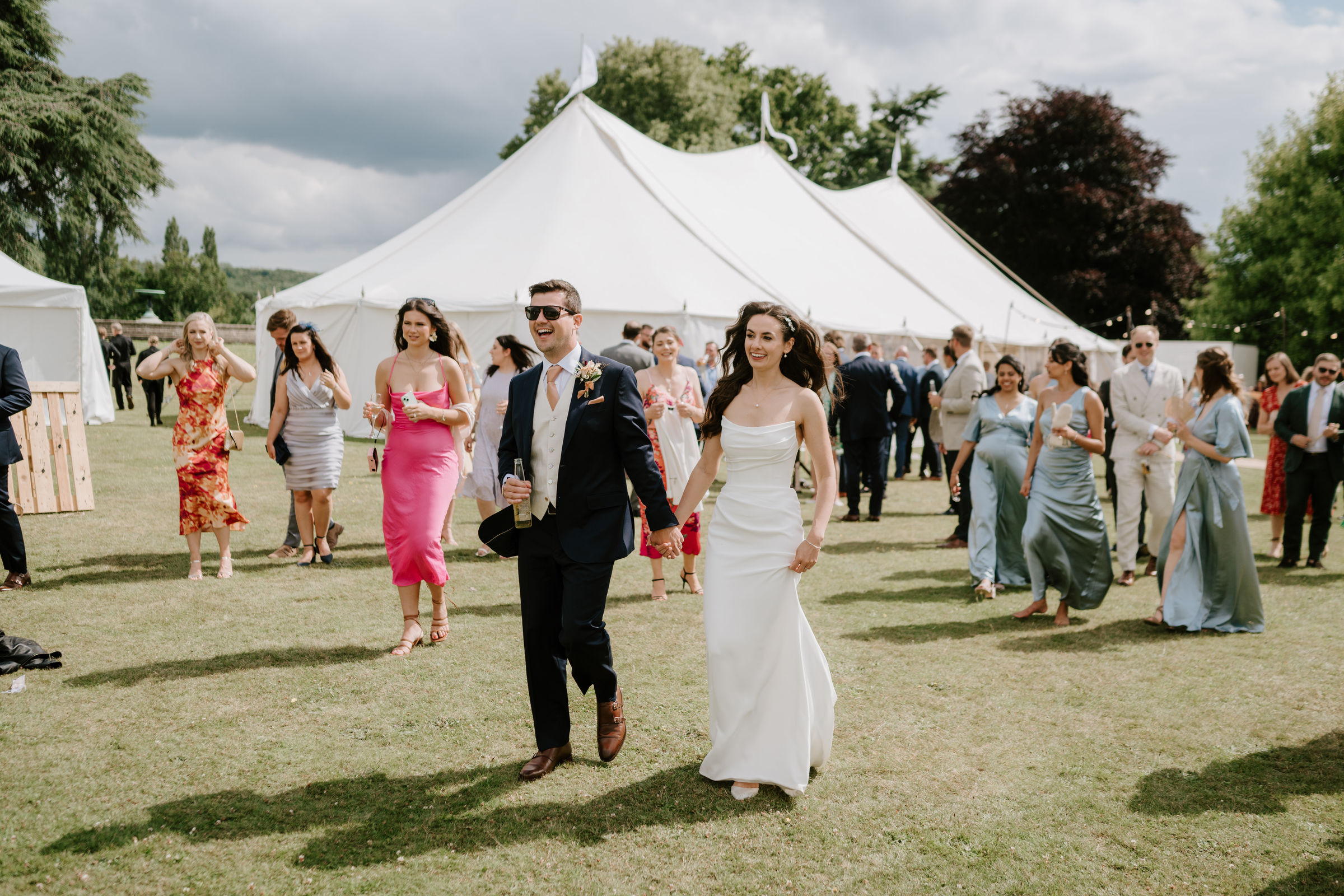 Guests crossing the lawn in the afternoon sun