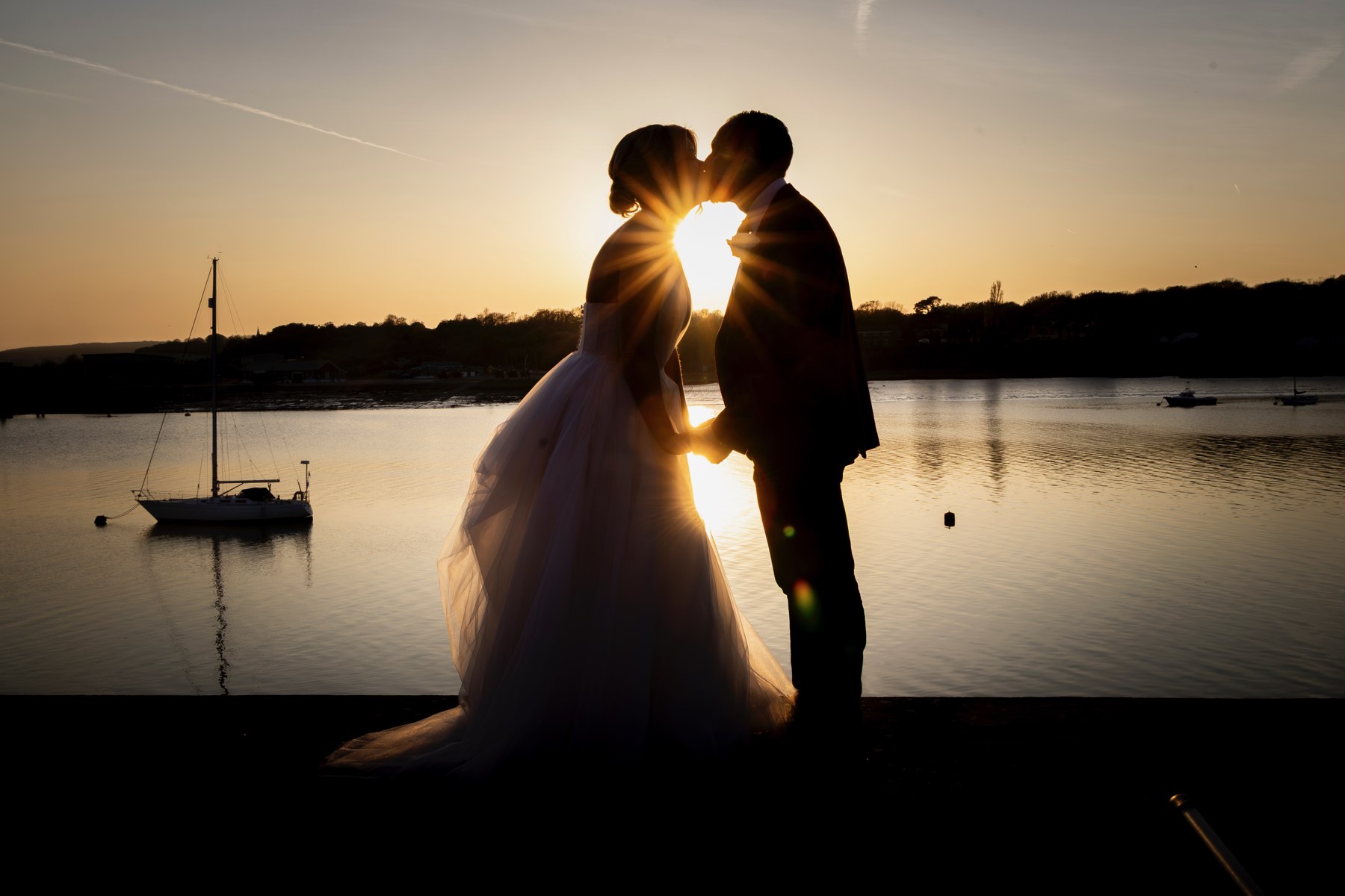 A couple beside the river at sunset at Copper Rivet Distillery