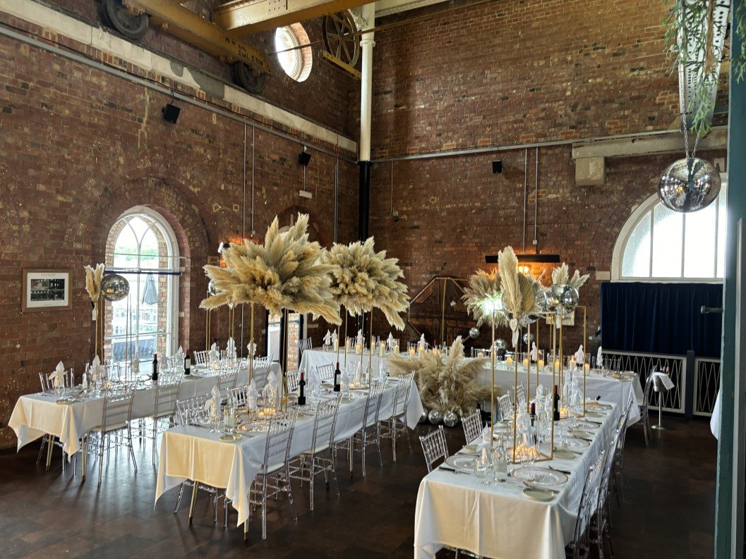 Reception tables inside the pumphouse at Copper Rivet Distillery