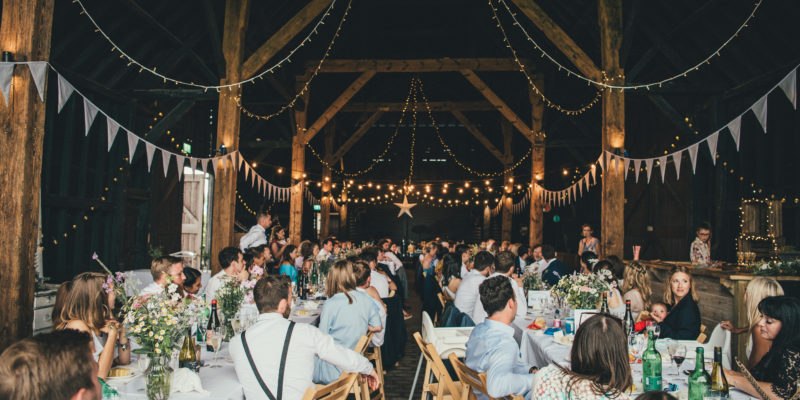 Guests celebrating beneath the barn beams at Elmley Nature Reserve