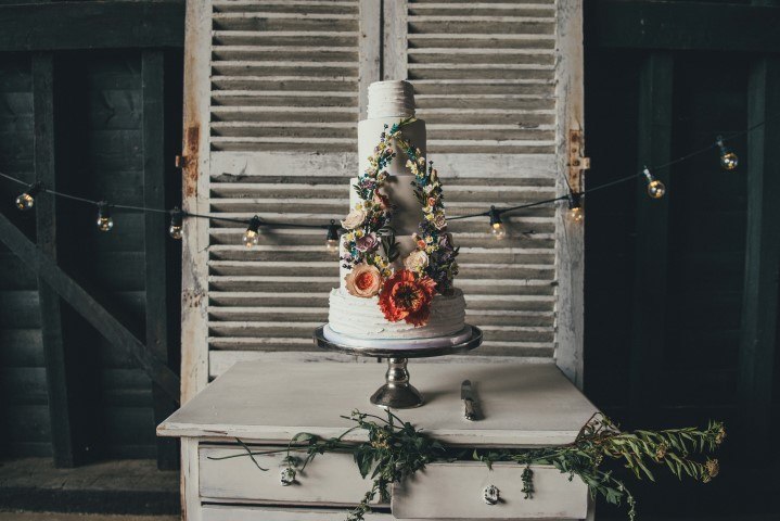 A wedding cake against rustic shutters at Elmley Nature Reserve