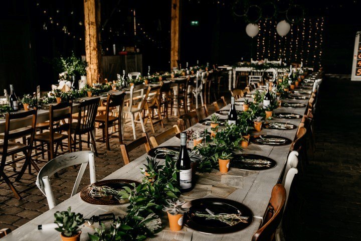 Long reception tables decorated with flowers at Elmley Nature Reserve