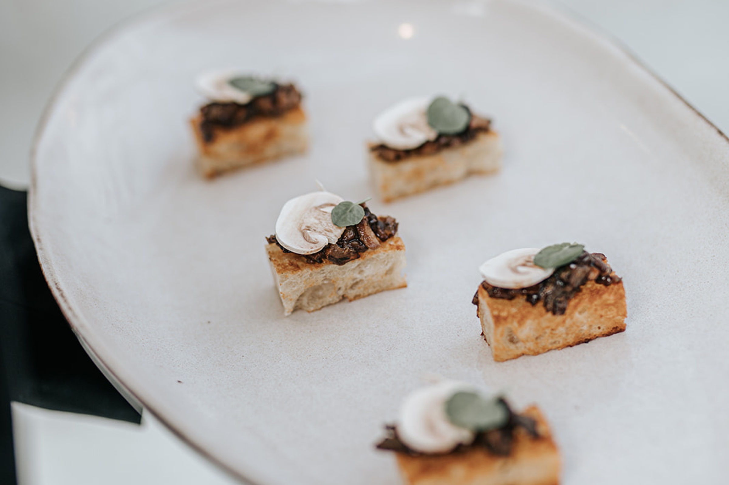 Canapé squares with crème fraîche and radish