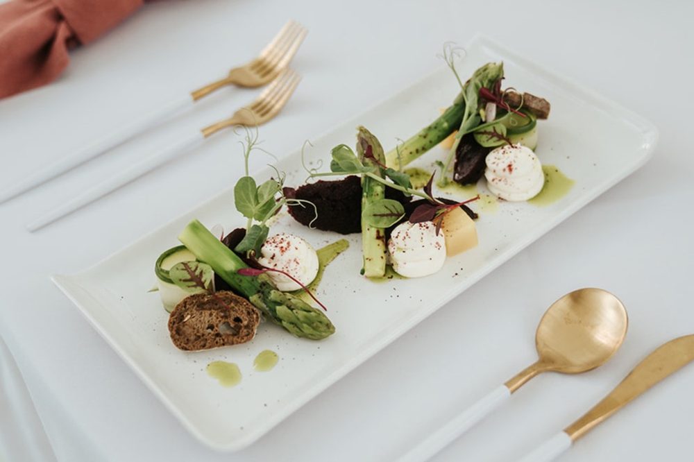 A plated starter, dressed with micro herbs and edible flowers