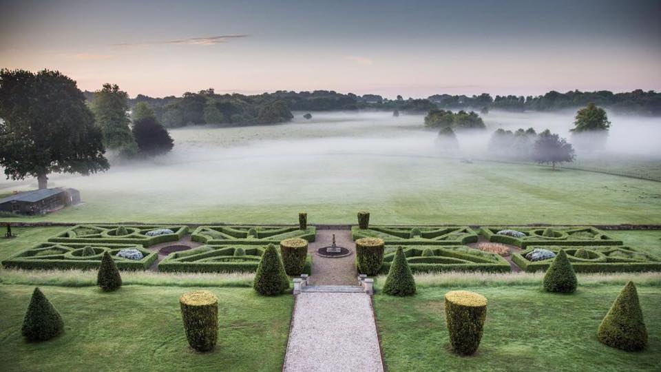 The formal garden overlooking misty parkland at Goodnestone Park