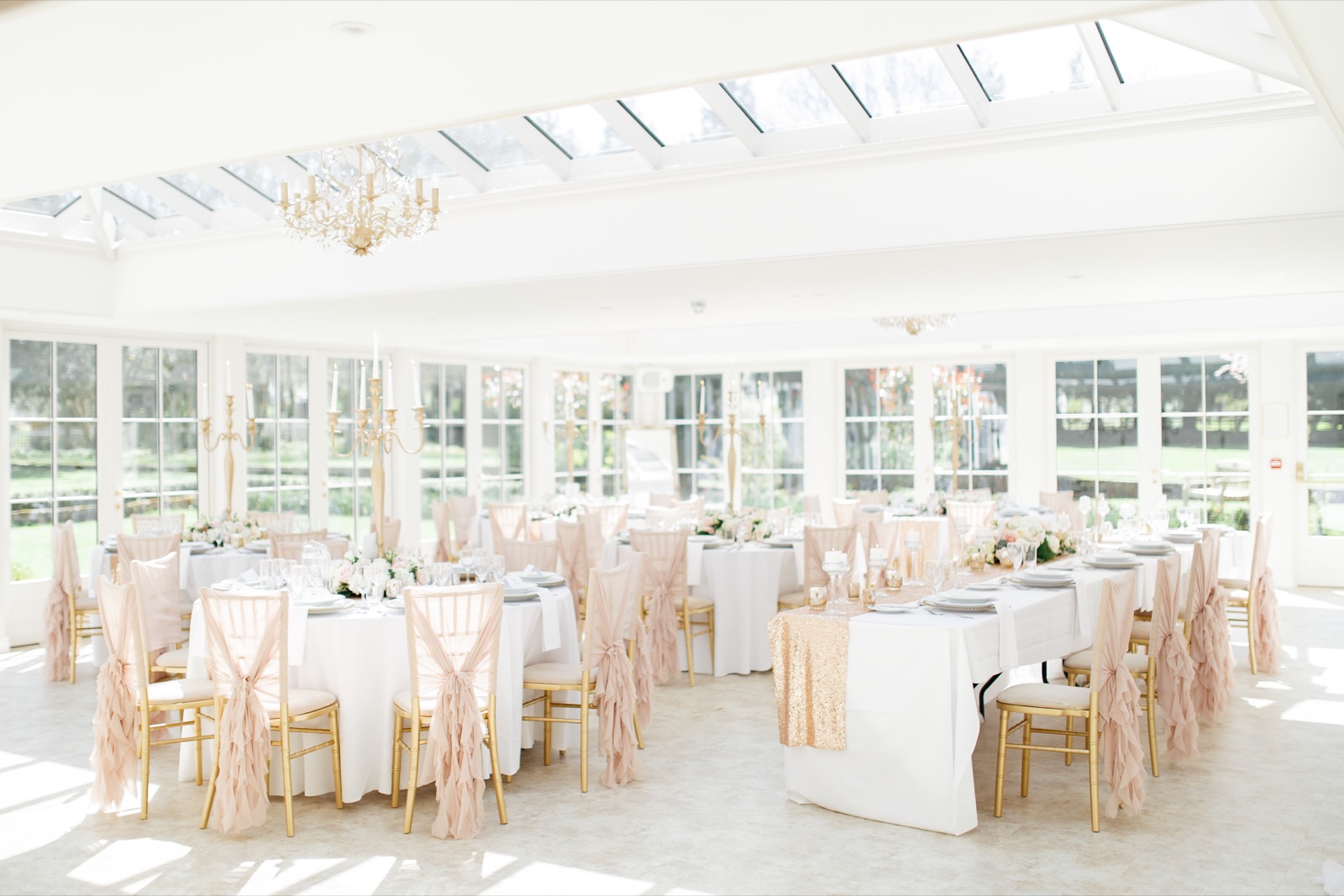 Wedding reception tables in the bright Orangery