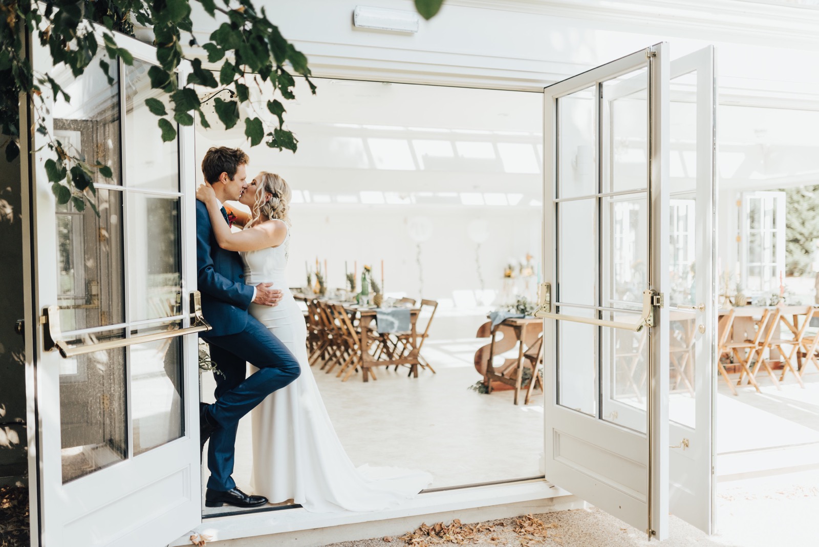A couple beside the open Orangery doors