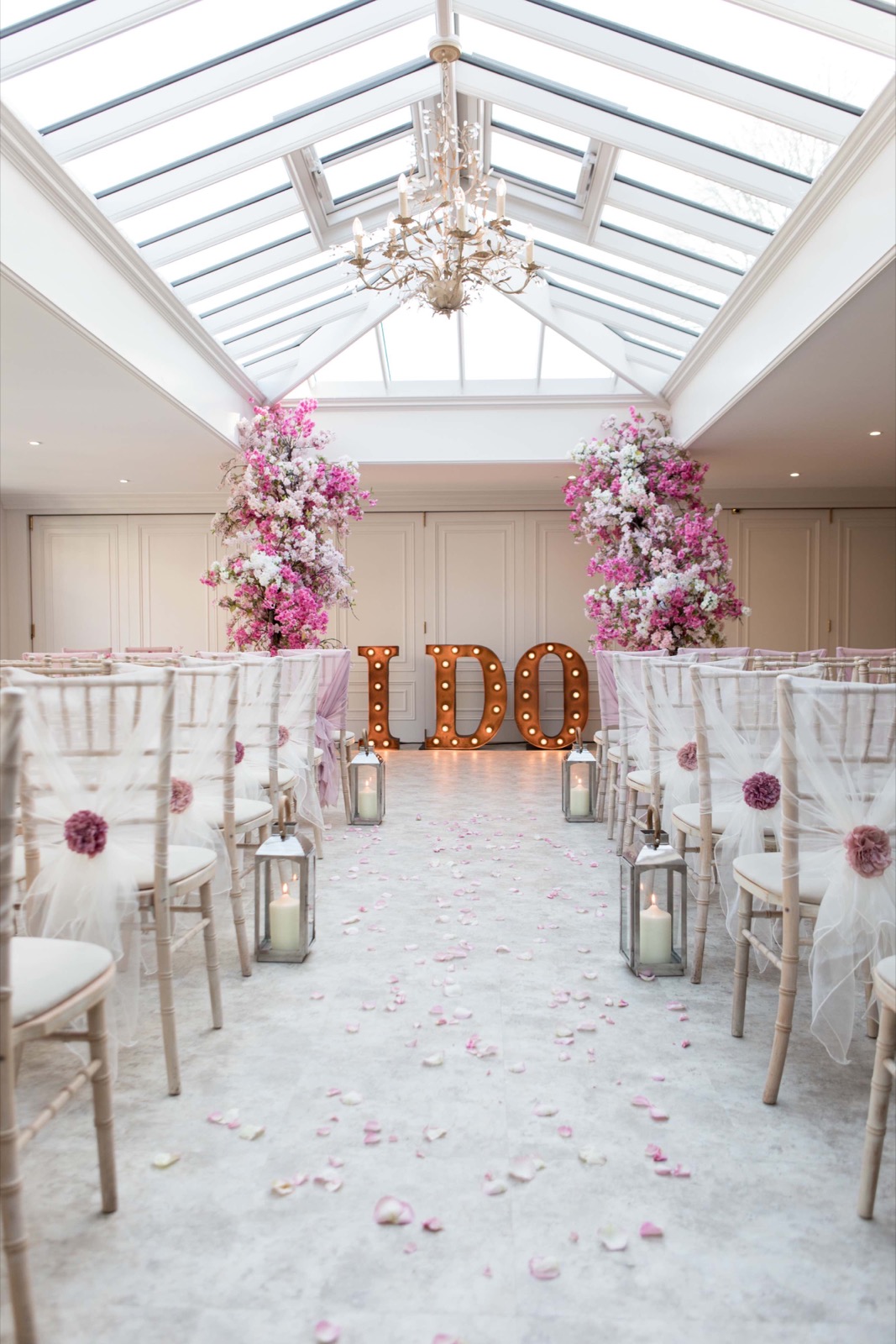 Flowers lining the Orangery wedding ceremony aisle