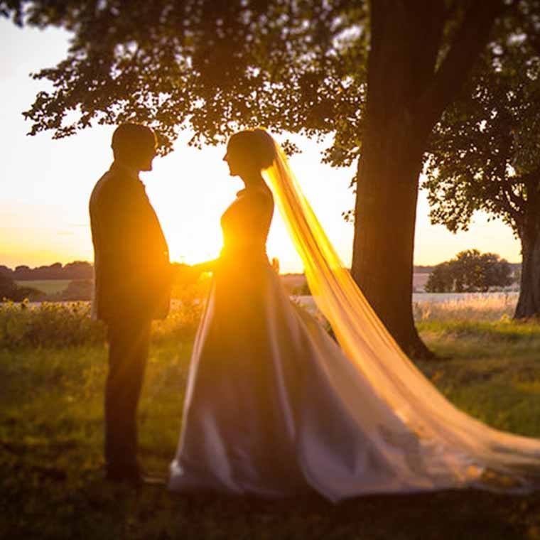 A couple in the grounds at sunset at Knowlton Court