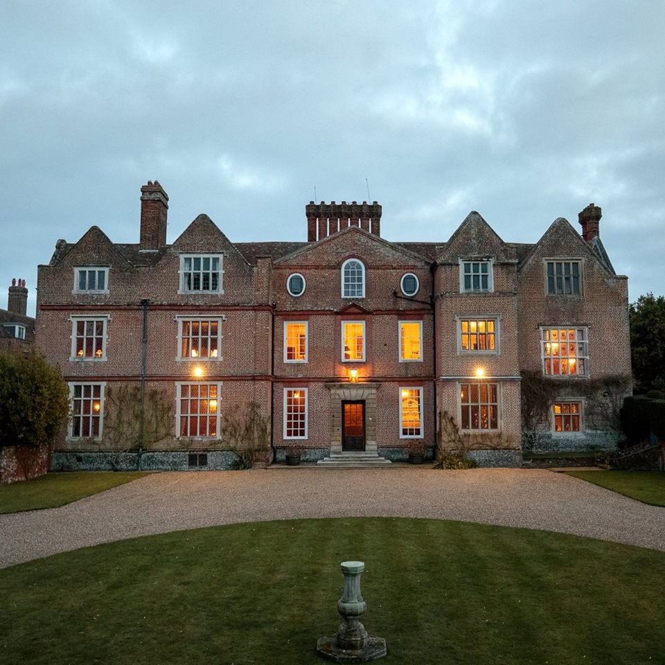 The house illuminated at dusk at Knowlton Court