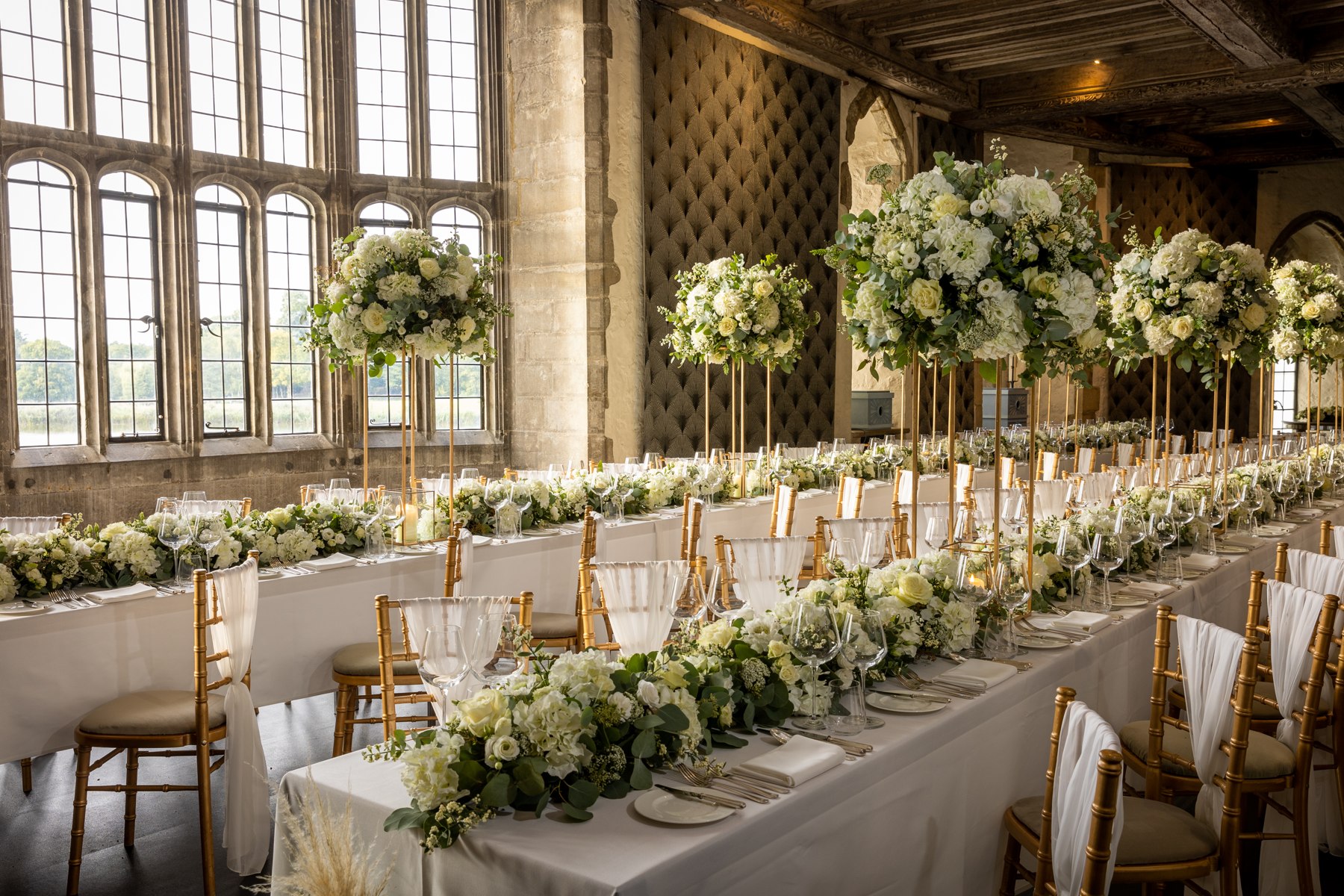 A long wedding table with floral centrepieces at Leeds Castle