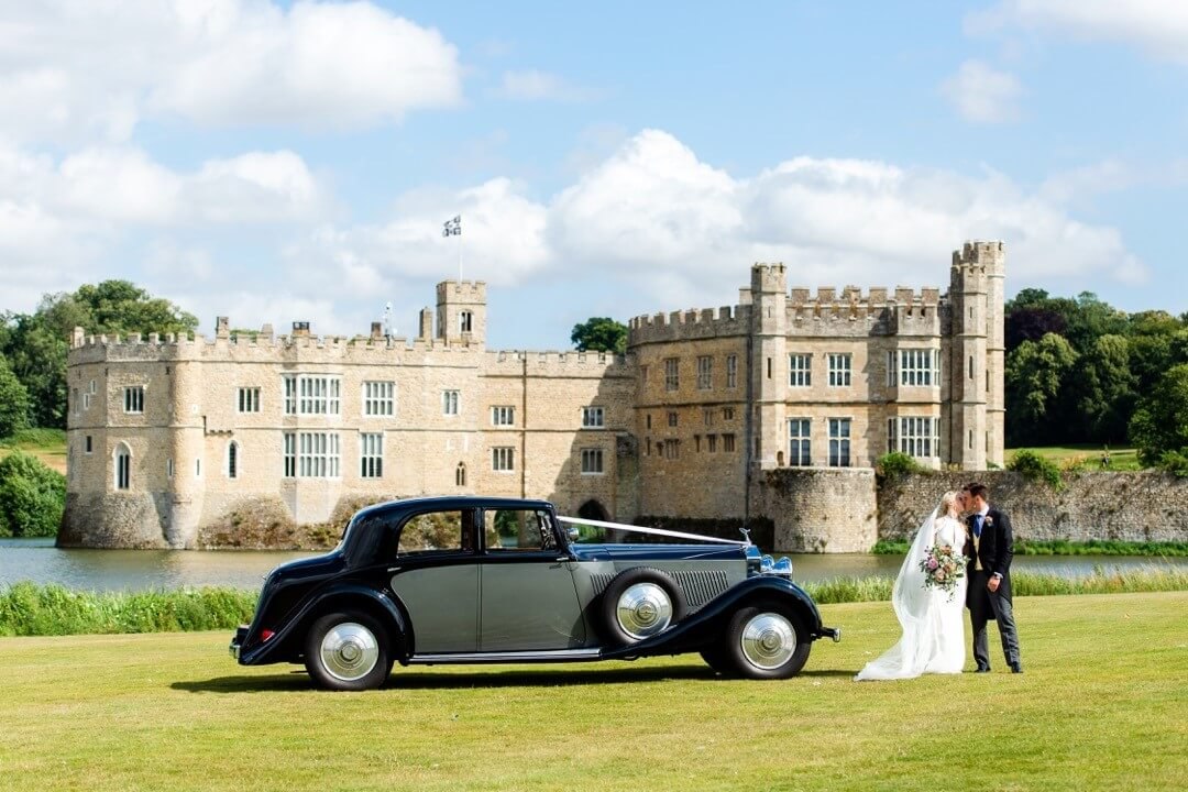A wedding car on the lawn beside the castle at Leeds Castle