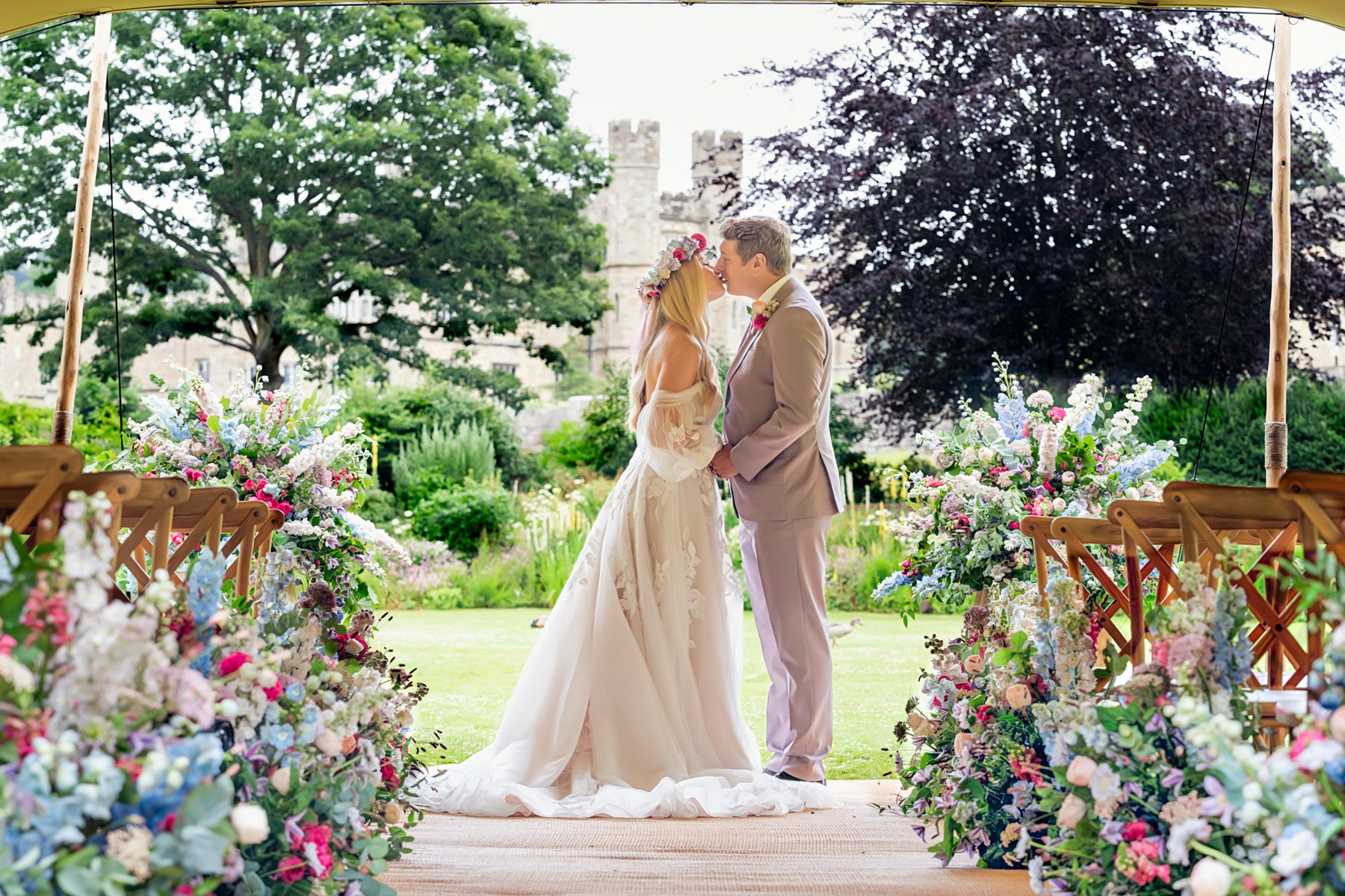 A couple in a garden ceremony setting at Leeds Castle