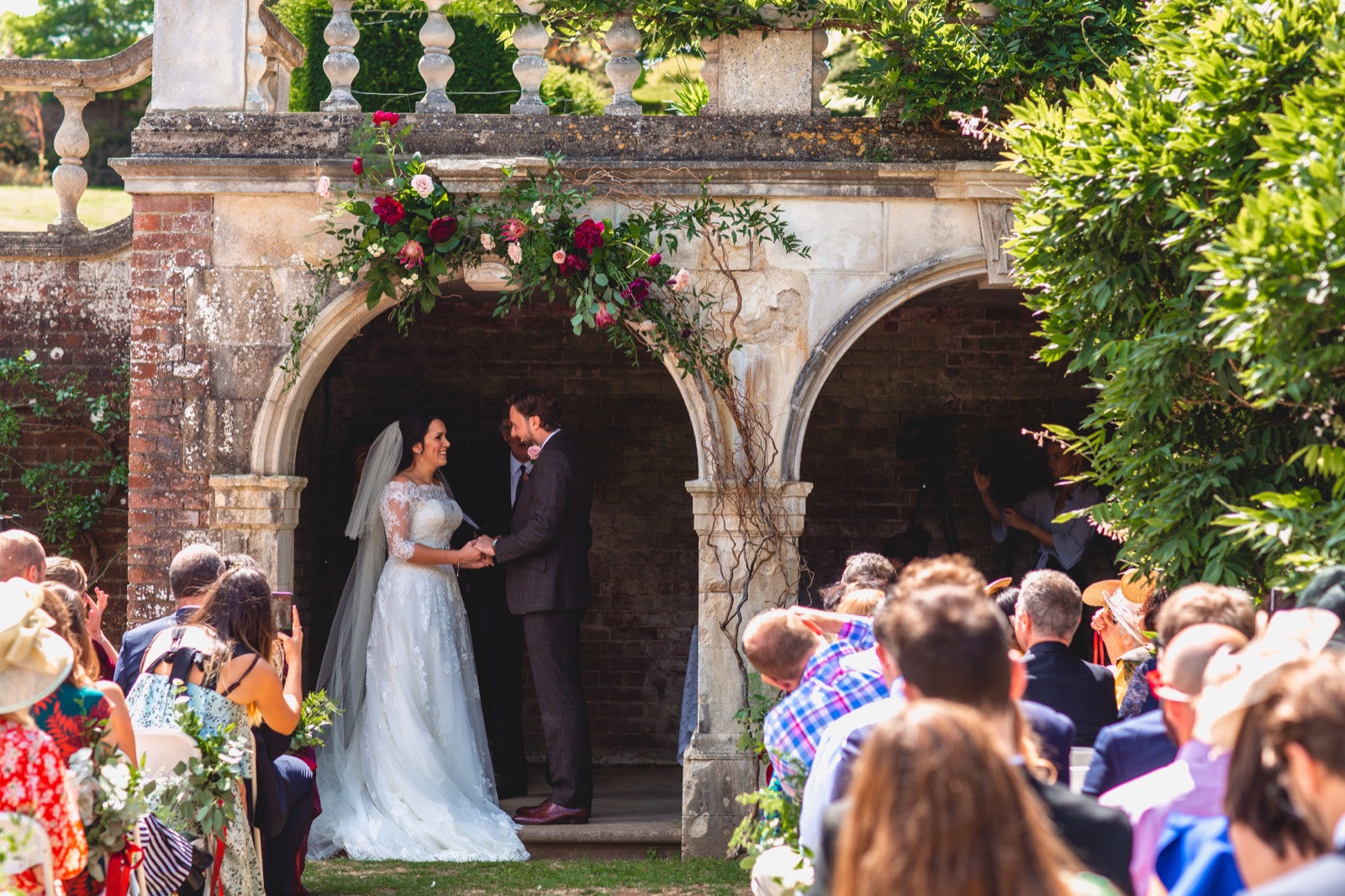 A wedding ceremony beneath the garden arches at Mount Ephraim