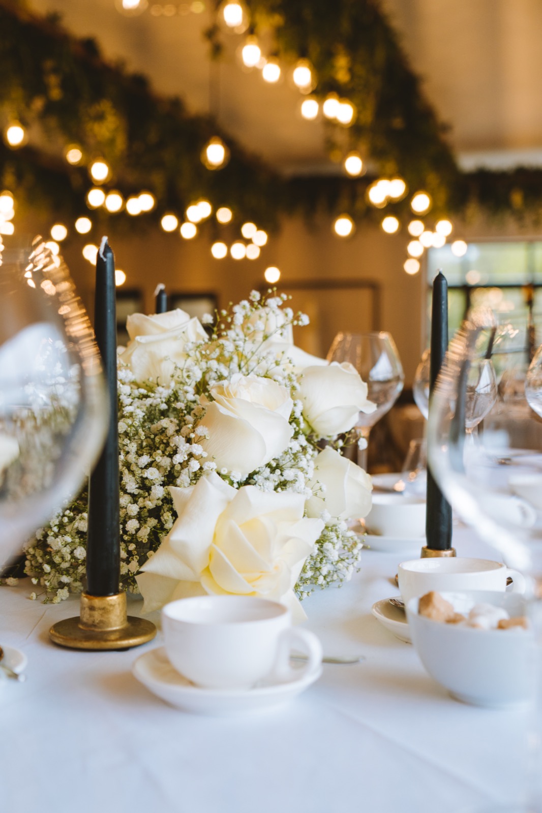 Floral table decorations beneath the lights at Oad Street