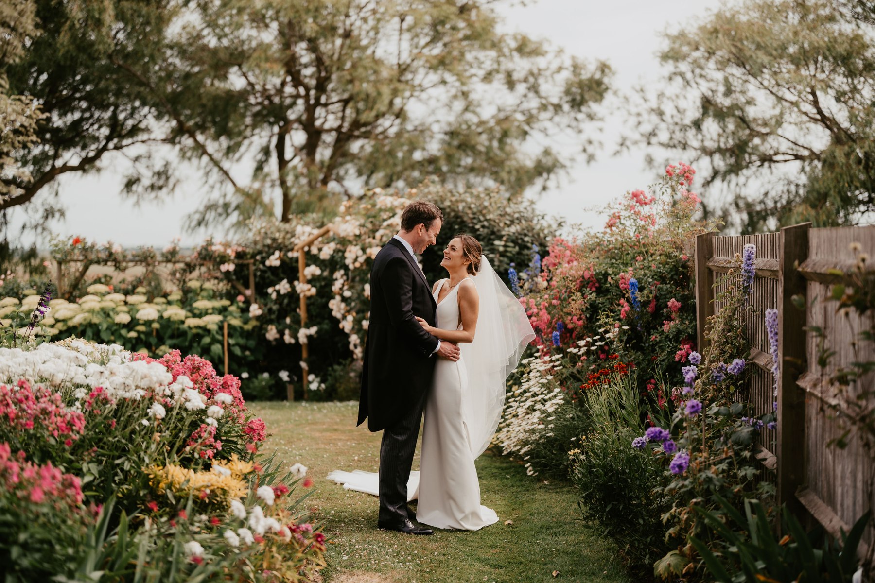 A couple among garden flowers at Odo’s Barn