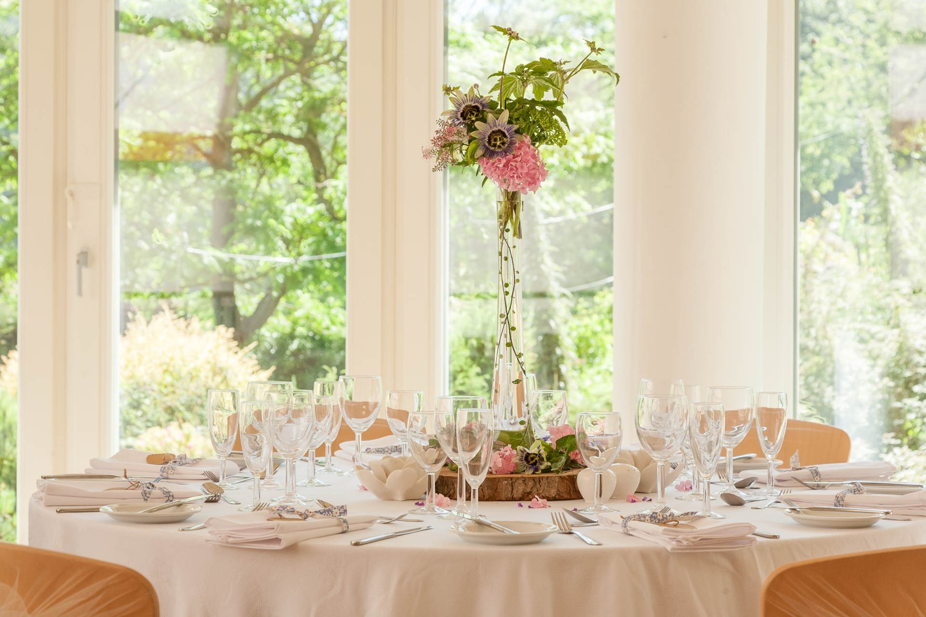 Wedding tables beside the garden windows at The Pines Calyx