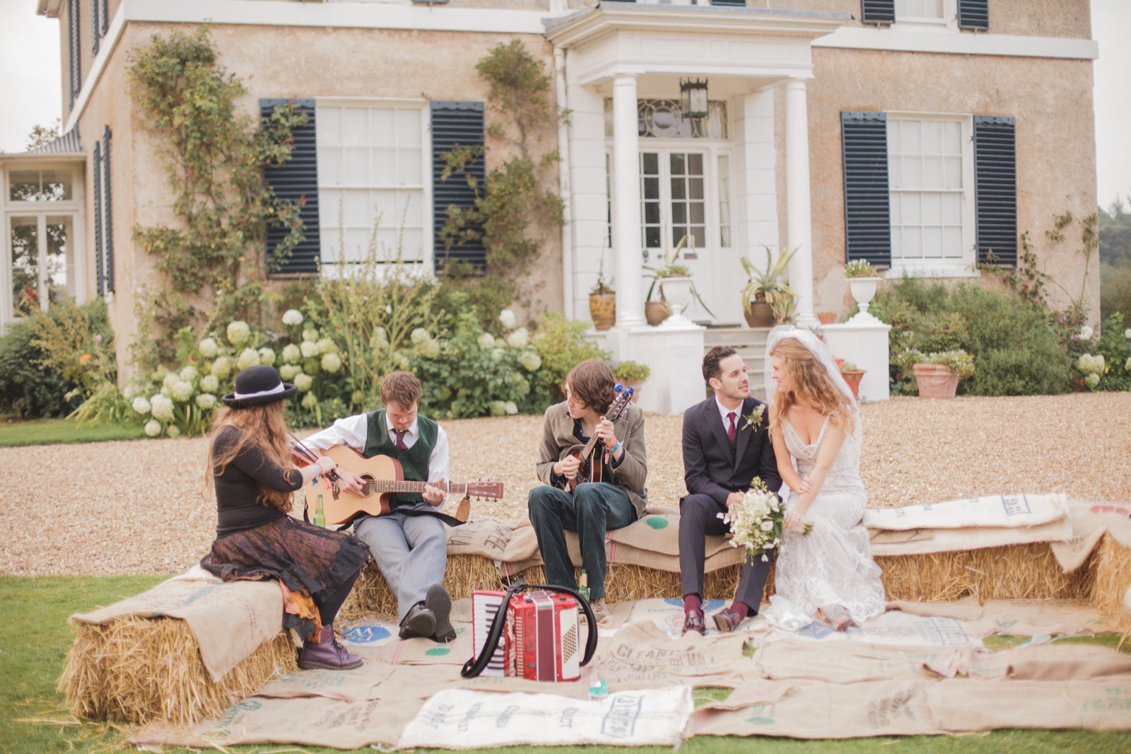 Musicians and a wedding couple outside Preston Court house