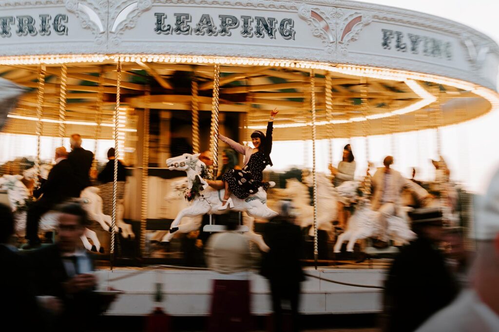 Guests riding the vintage carousel at Preston Court in daylight