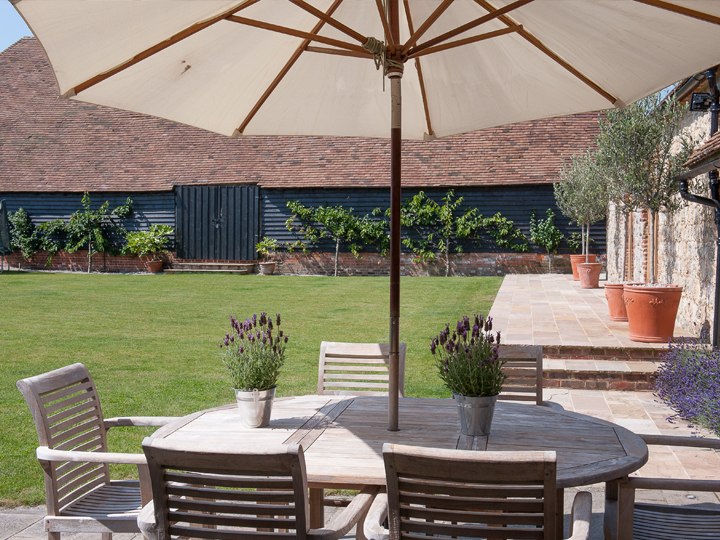 Outdoor seating overlooking the lawn at Ruffynes Barn