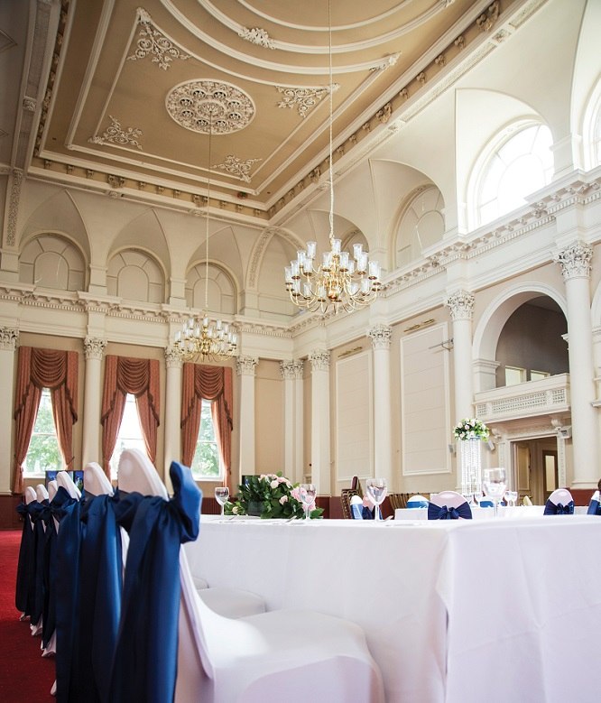 A reception table beside tall windows at The Corn Exchange