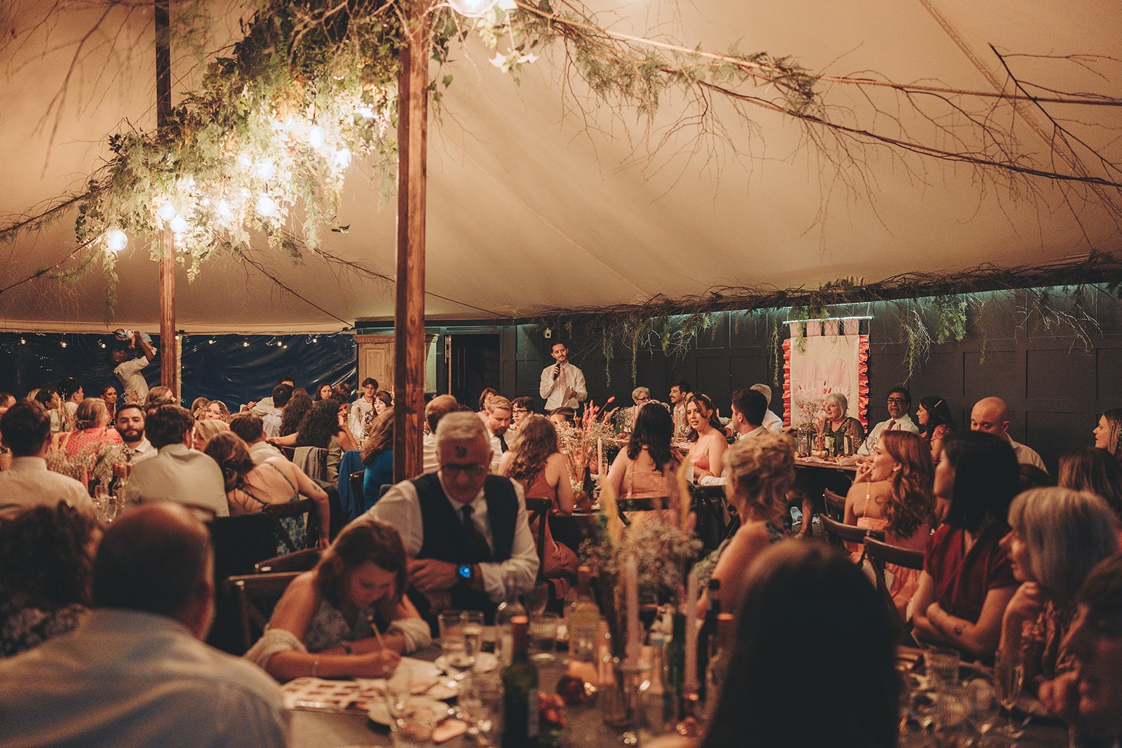 Guests dining beneath a decorated canopy at The Dreys