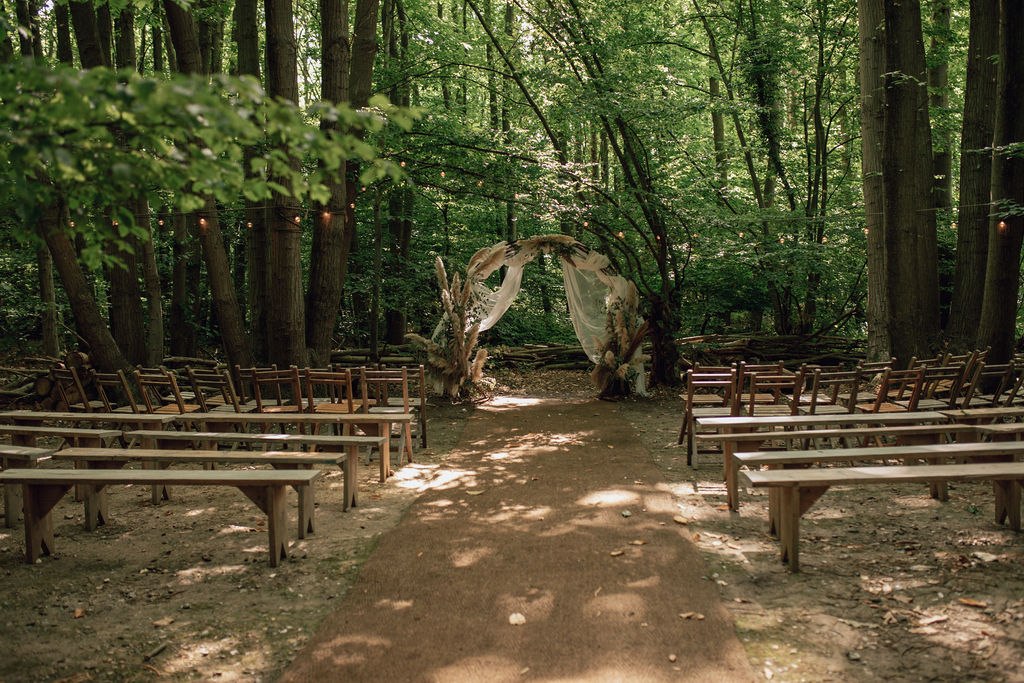 Woodland ceremony seating and floral arch at The Dreys