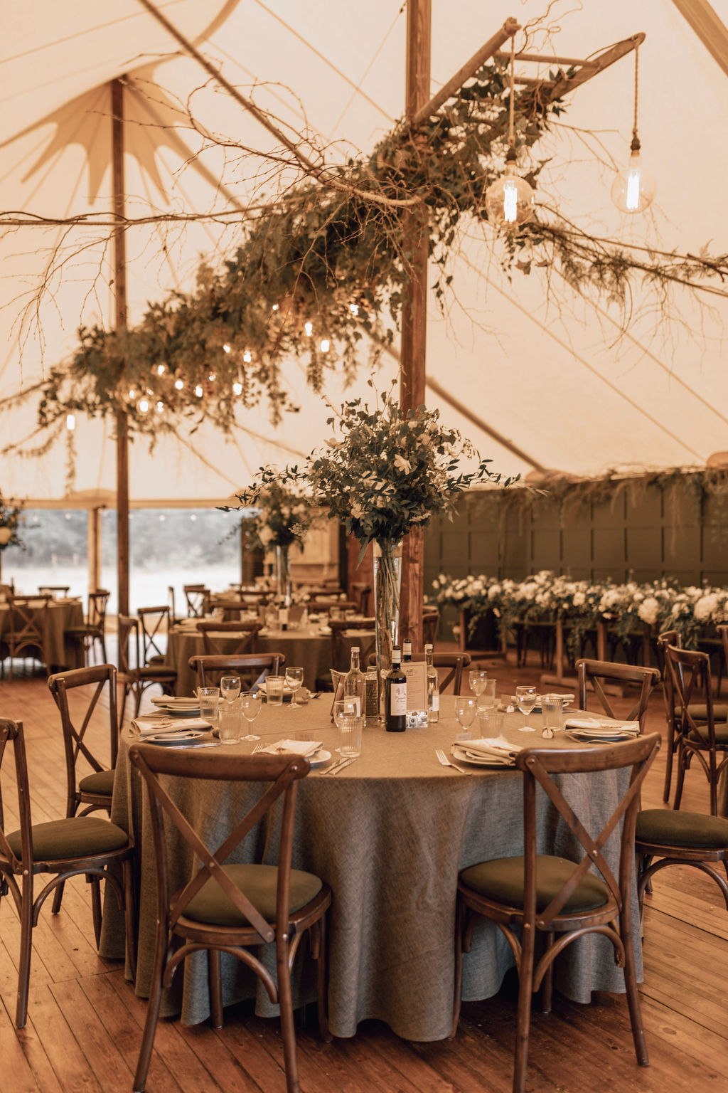 Reception tables beneath a canopy at The Dreys