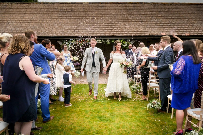 A couple walking between their wedding guests at The Night Yard