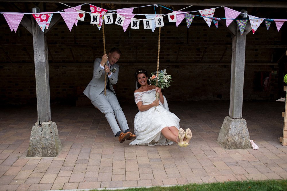 A couple sitting beneath the barn cloister at The Night Yard