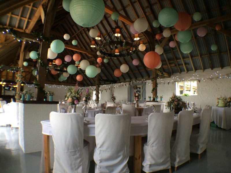 Tables set beneath the timber roof at The Red Barn