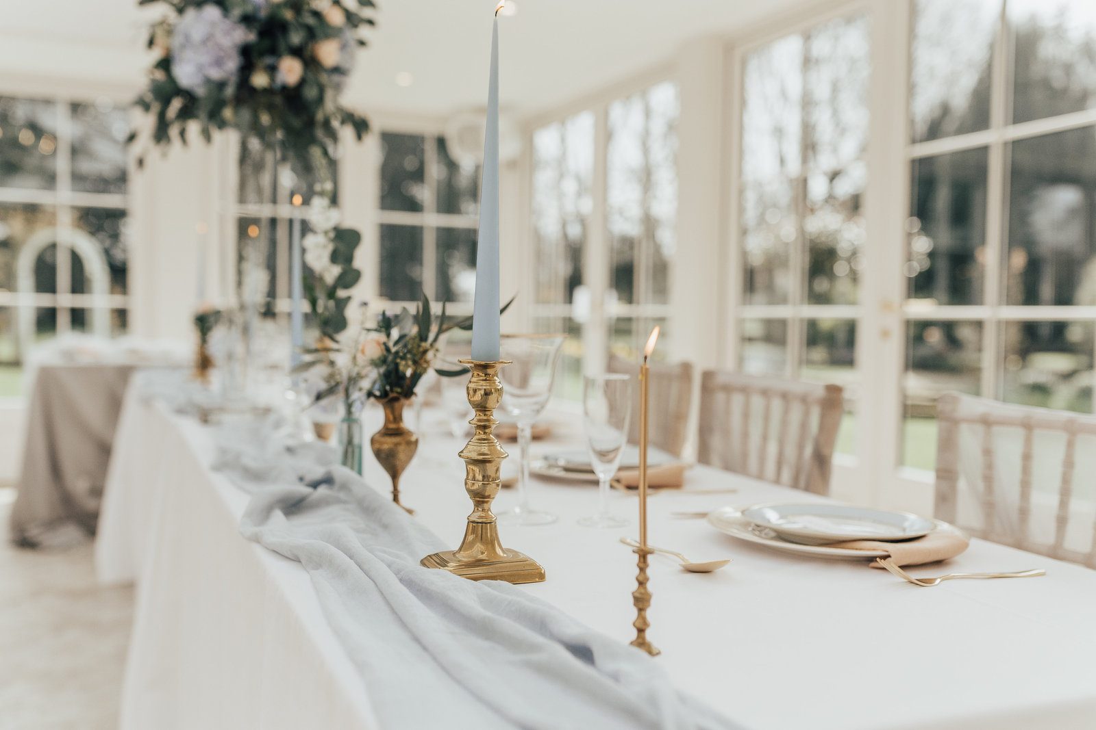 Brass candlesticks down the top table in the Orangery at Hayne House