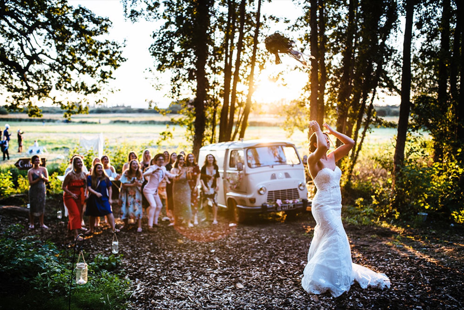 A bride throwing her bouquet to guests at Wilderness