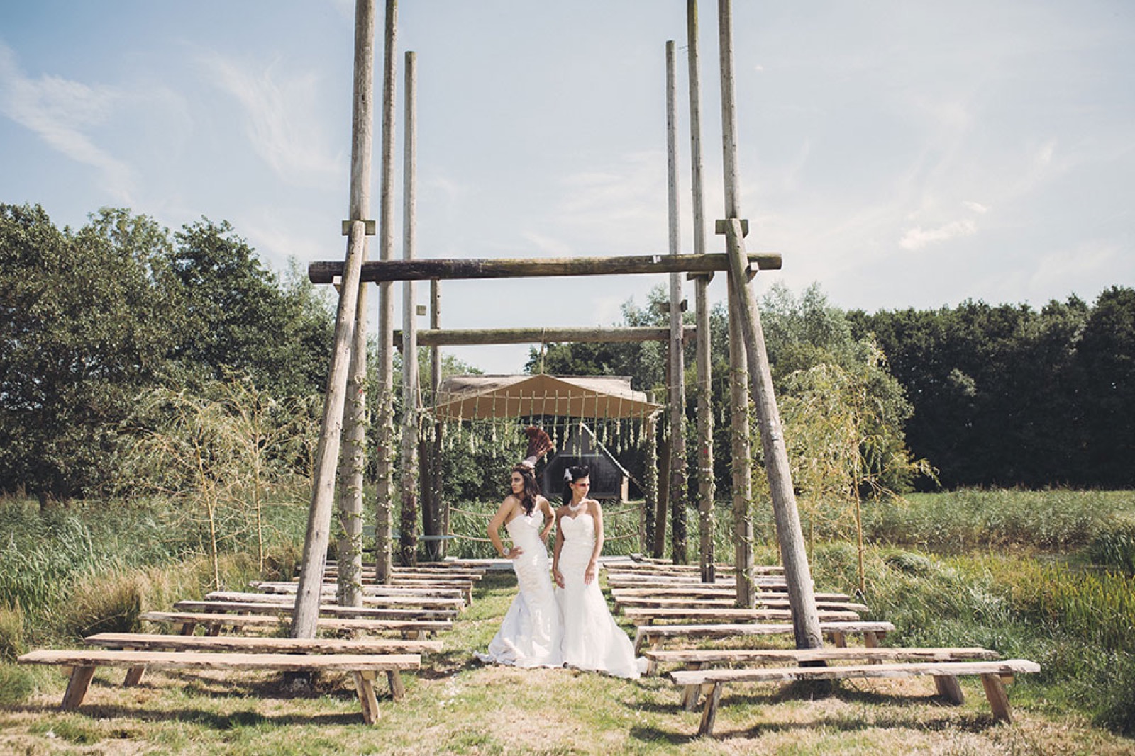 A couple in the outdoor ceremony area beside the lake