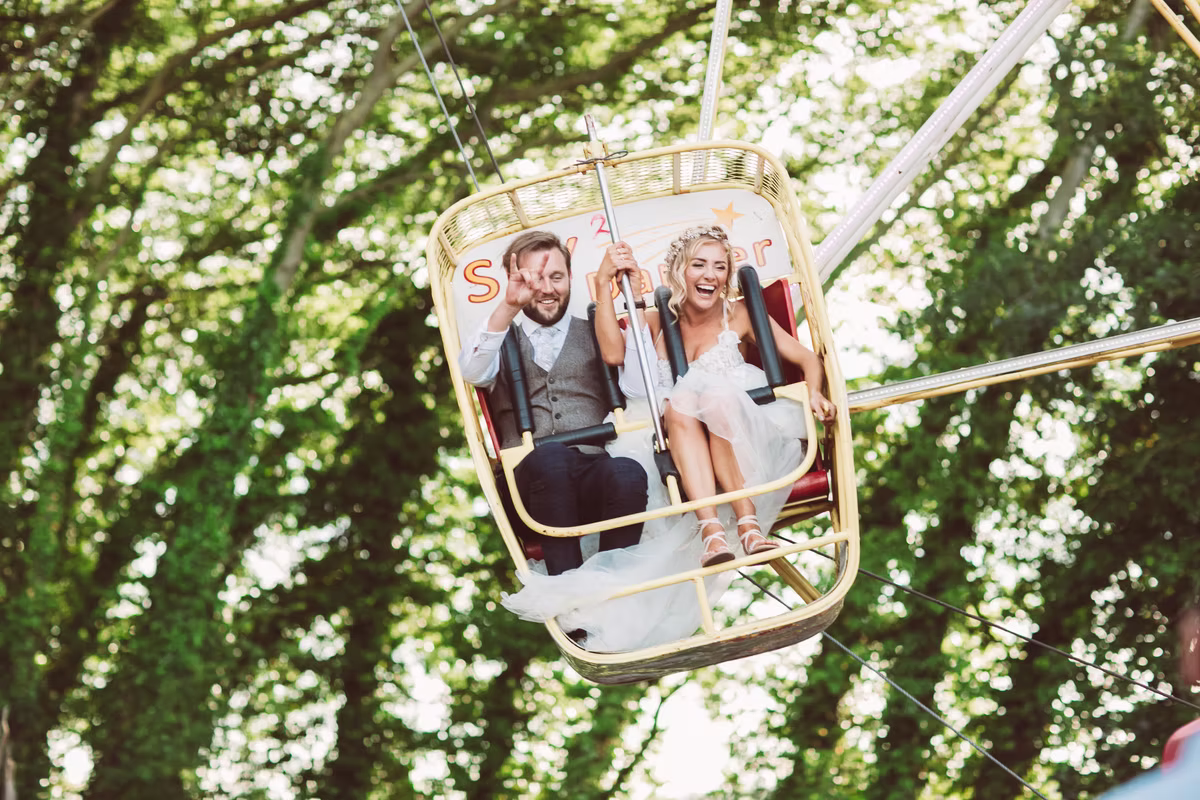 Wedding guests enjoying a fairground ride at Marleybrook House