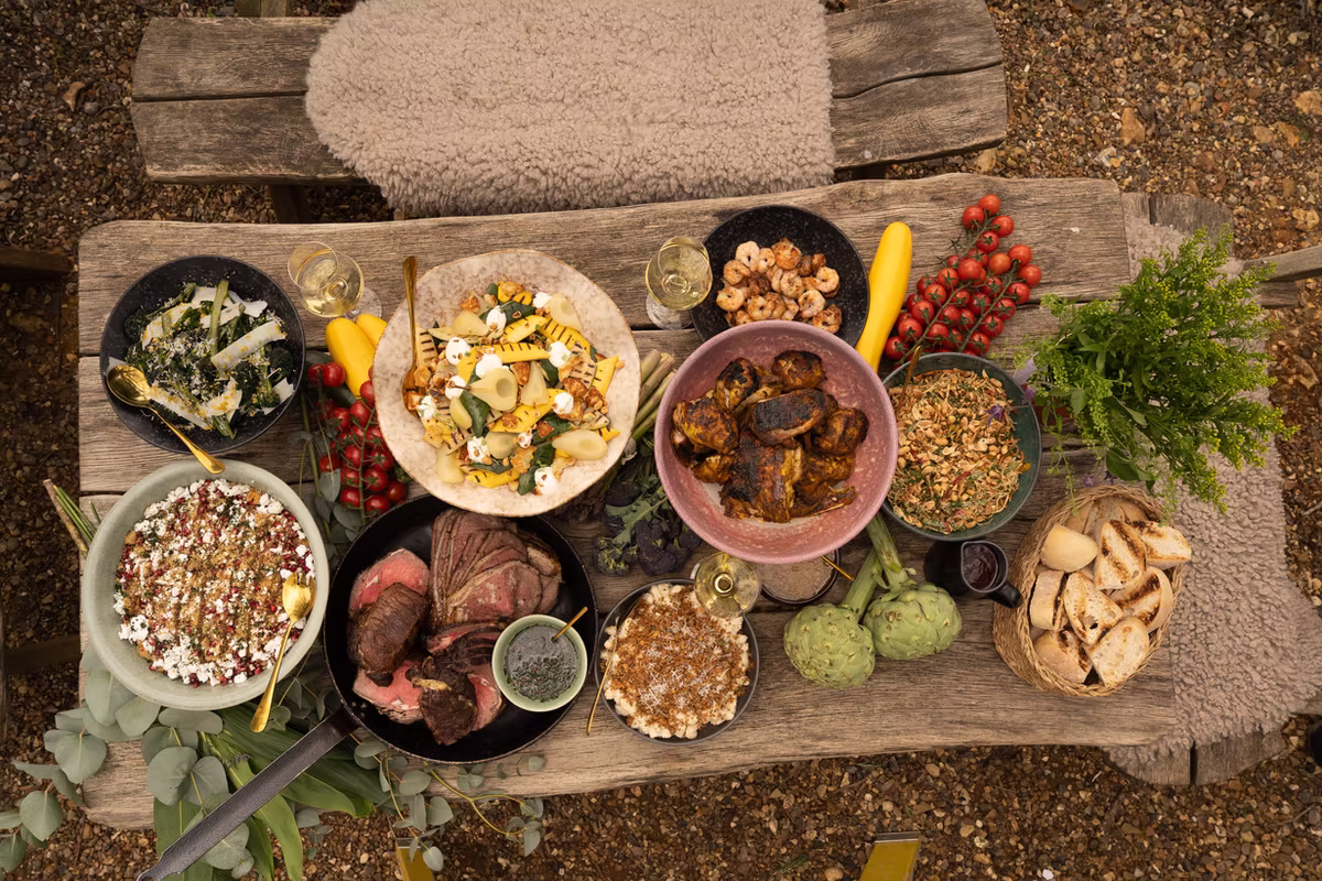 A table filled with feasting dishes, salads and sharing platters