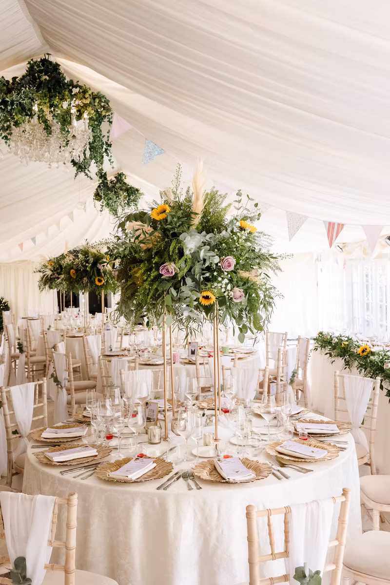 Floral centrepieces inside the wedding marquee at Marleybrook House