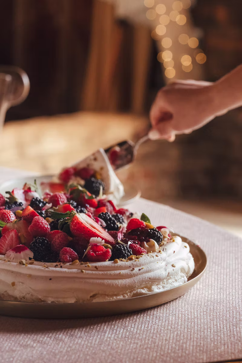 A sharing pavlova topped with summer berries