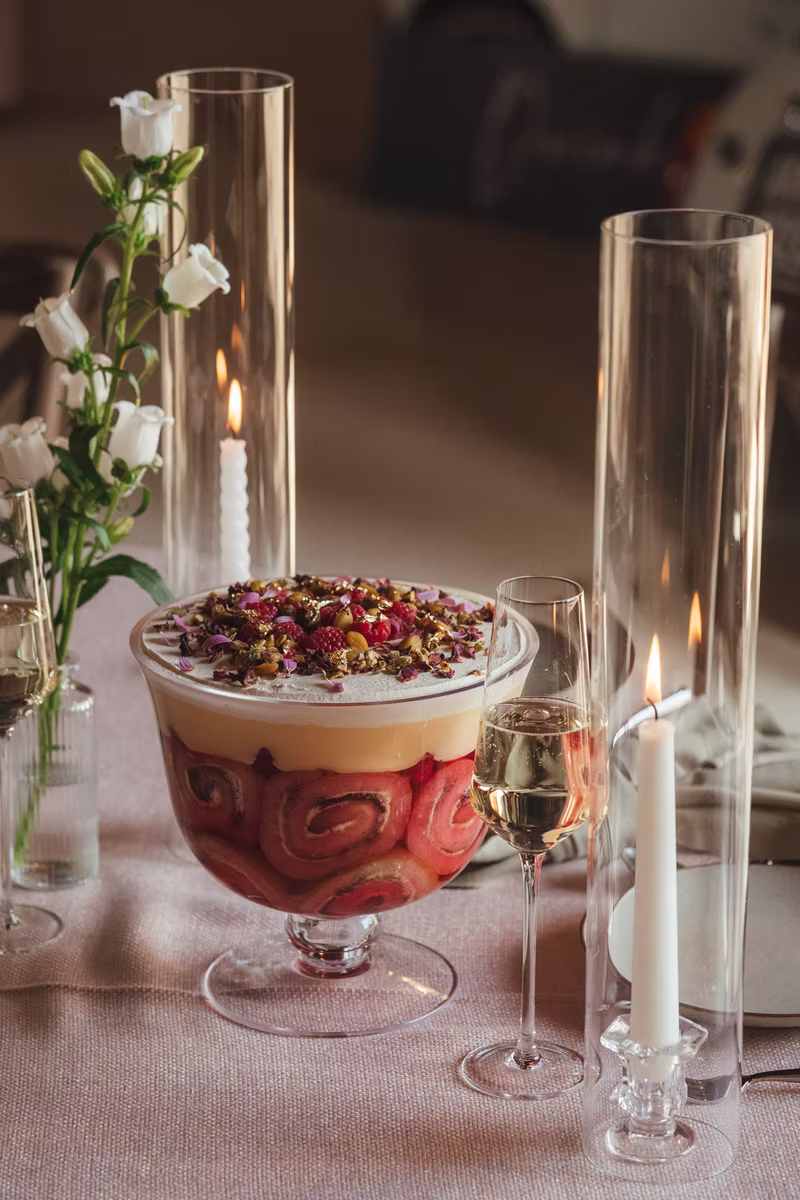 A trifle layered in a footed glass bowl