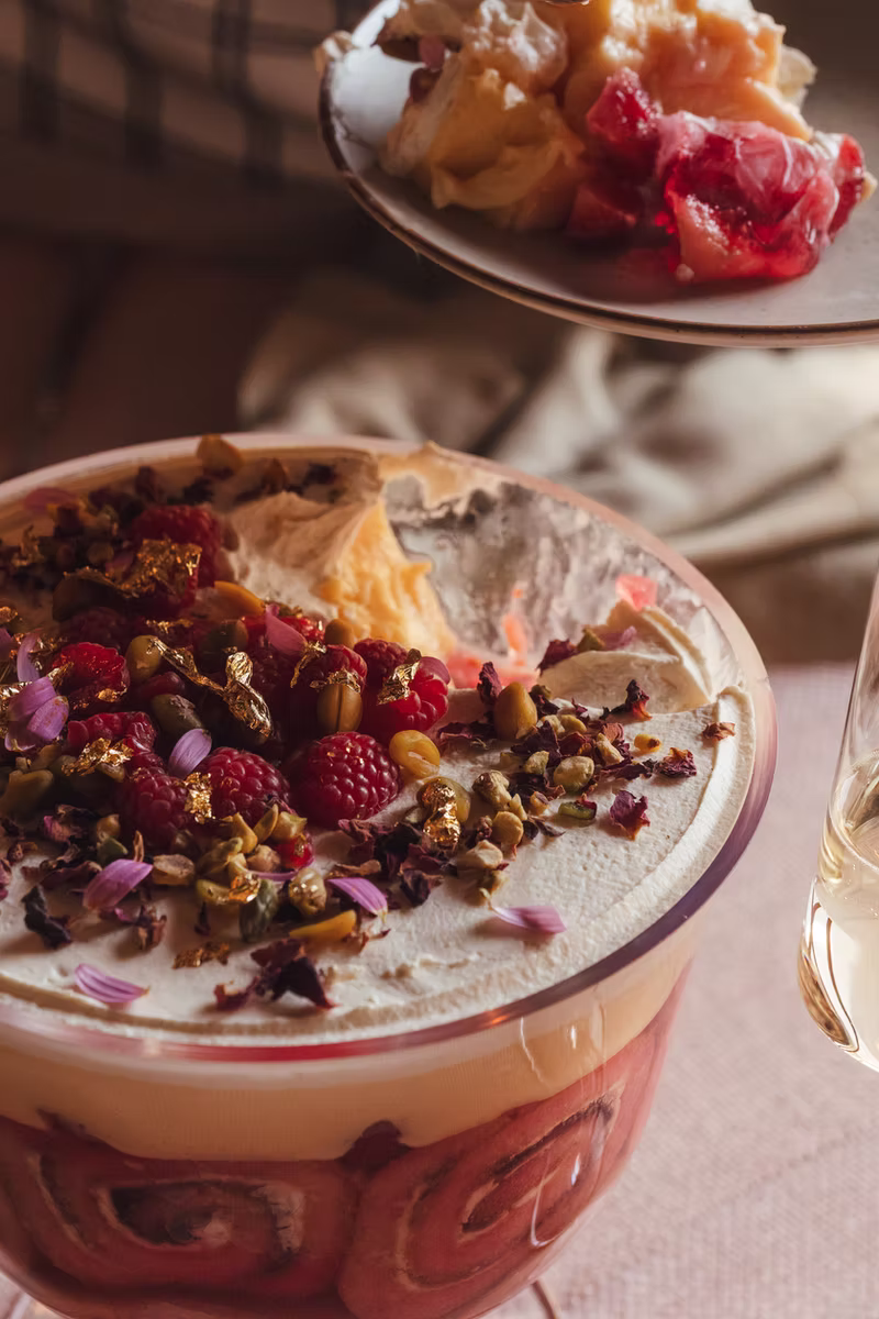 Traditional trifle being served from a glass bowl