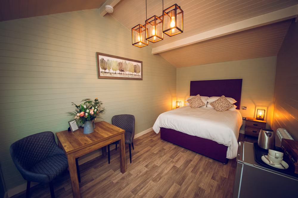 A double bedroom with a dining table at Winters Barns